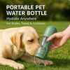 Labrador retriever drinking from a portable pet water bottle in a sunny park.